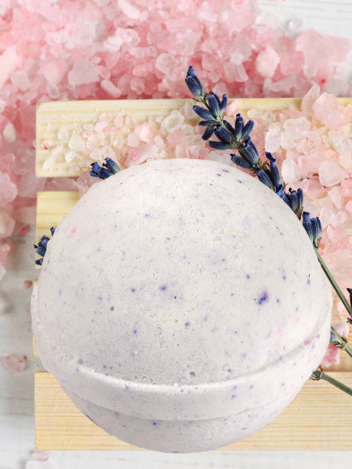 Pale lavender colored bath bomb with flecks of lavender flowers throughout.