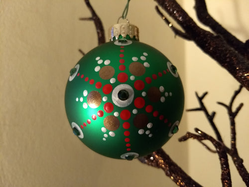 Gold and red design on a green ornament. Embellished with crystal. 