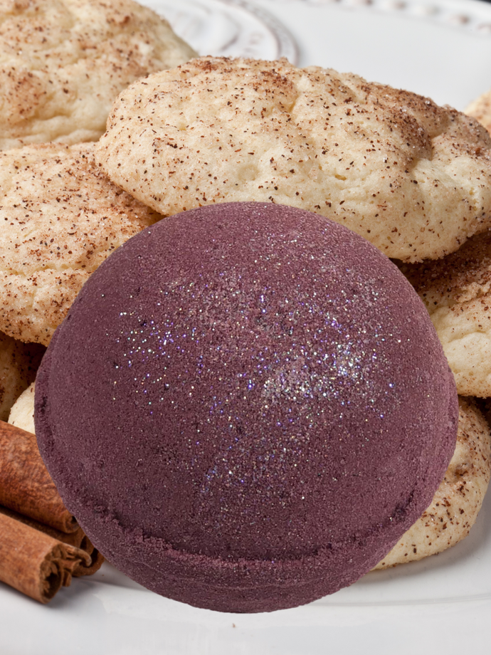 Chocolate colored bath bomb with a sprinkling of glitter on top.