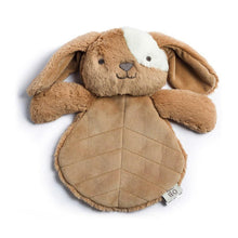 Load image into Gallery viewer, A soft tan bunny with a flattened paddle shaped body. It has nubby arms, long ears and a patch of white fur around one of it&#39;s eyes.
