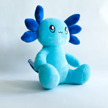 Load image into Gallery viewer, A smiling anthropomorphic blue axolotl sits. It&#39;s body is a soft blue, while it&#39;s external frilly gills are a darker blue.
