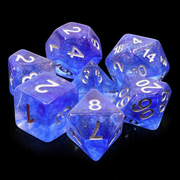 A tabletop dice set in a sparkling, transparent deep blue blue tone with white numbers.
