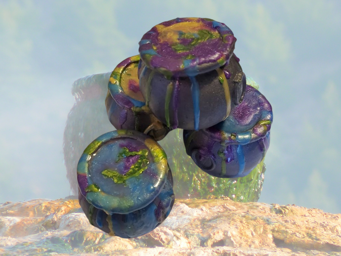 Colorful cauldron-shaped soap with a potion made of soap bubbling over.