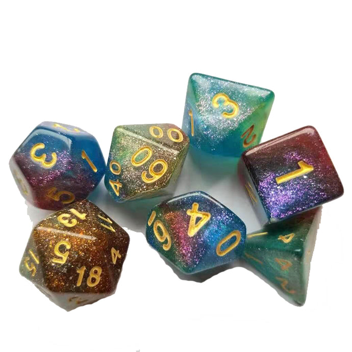 A tabletop dice set in a gradient including sparkling gold, amber, blue, aqua, and purple, with gold numbers.