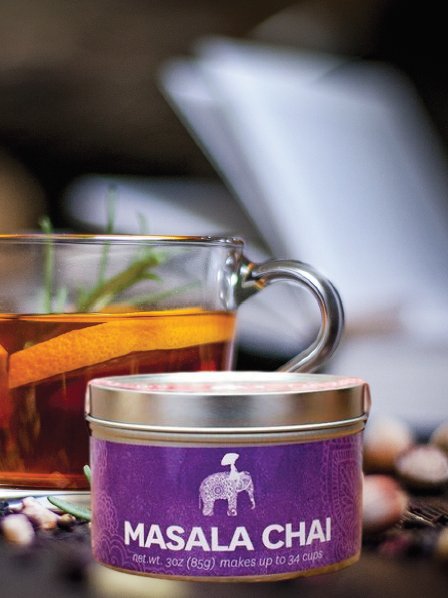 Loose leaf Masala Chai Tea in a reusable tin container, with bold font. Color-coded purple.
