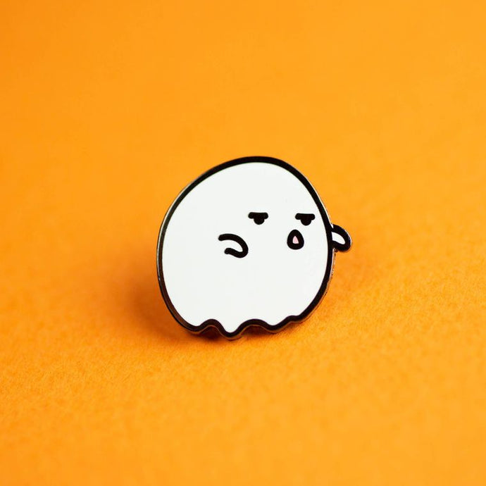 Enamel pin depicting a stylized ghost that does not look impressed.