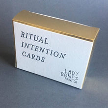 Load image into Gallery viewer, The box containing the cards, with the words &quot;Ritual Intention Cards,&quot; with the printing company, Lady Bones Printing Co. in the lower right-hand corner.
