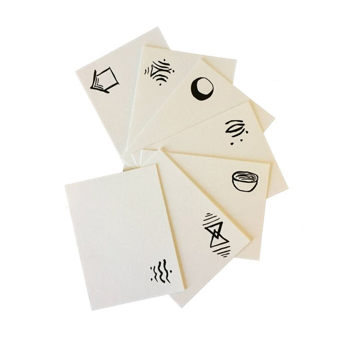 Sample of the cards, white with symbols written in the upper right-hand corner.