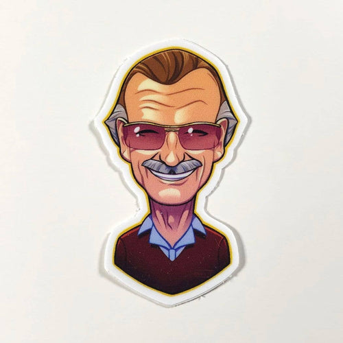 a caricature of a smiling Stan Lee bust, he is wearing a dark read shirt with a white collar and his signature glasses