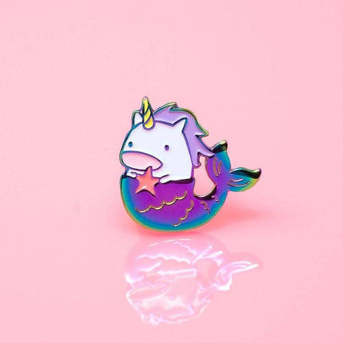 Enamel pin depicting a unicorn mermaid whose tail is in blue and purple, clutching a star.